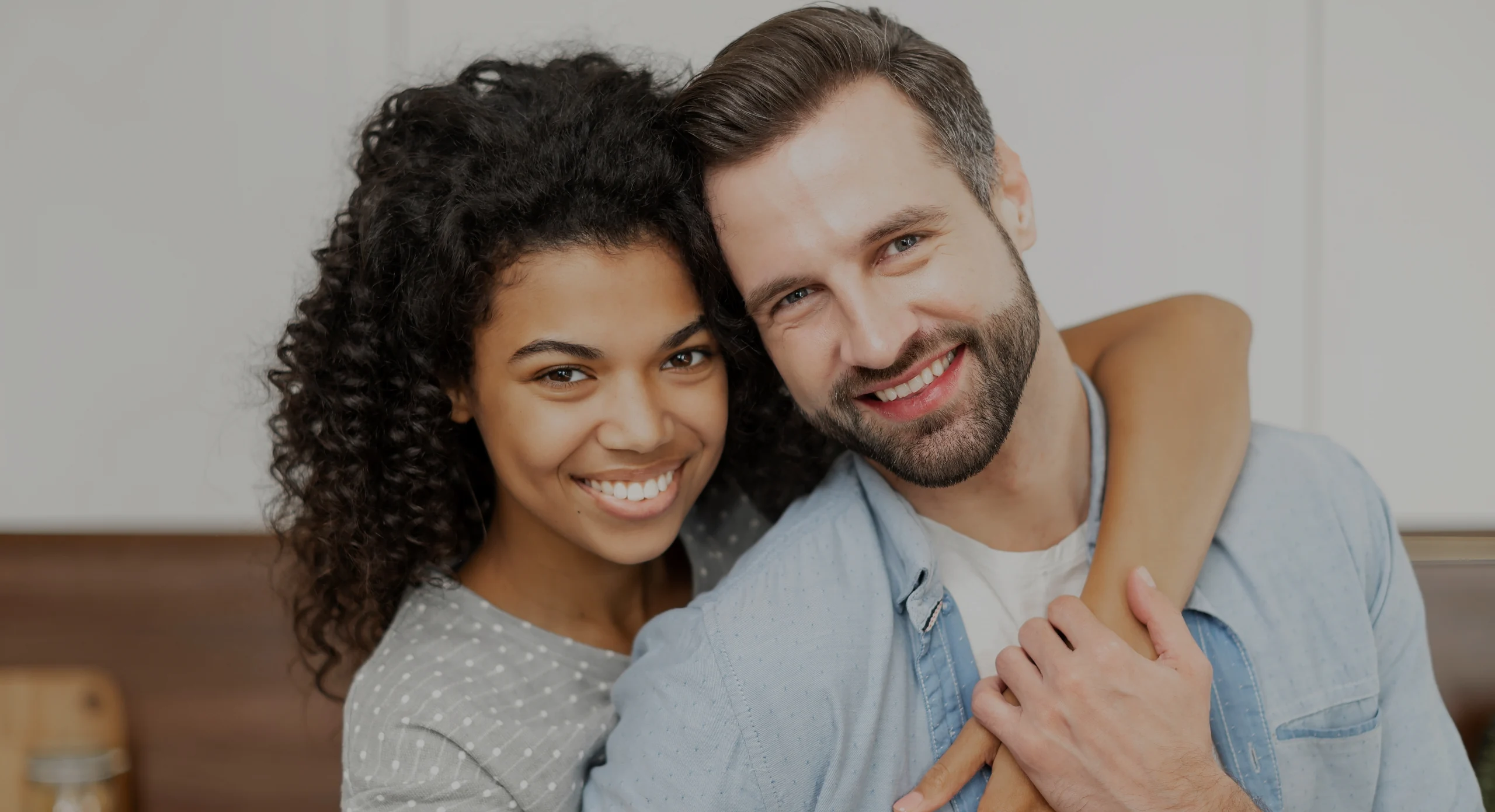 Interracial couple smiling at home