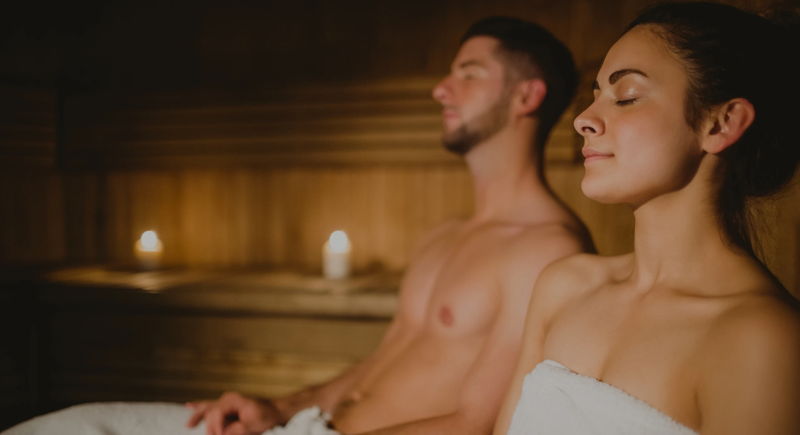 Relaxed couple sitting in the sauna